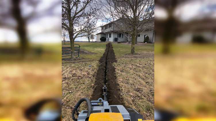 Trencher with armoured and sleeved hoses